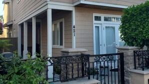 A two-story house with a beige exterior, white trim, and a stone base. - "Welcome to Your Ultimate Huntington Beach Get-a-way! 3-Blocks to the Beach!  (Huntington Beach)