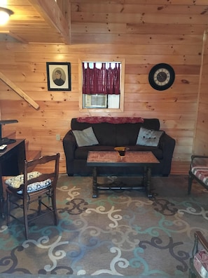 Un intérieur en bois avec un canapé, une table et une chaise.