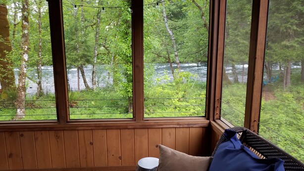 A room with large windows overlooking a forest and a river. - McKenzie Riverfront Cabin big screened-in porch, 1/2mi to Mckenzie River Trail (McKenzie Bridge)