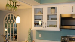 A kitchen with white cabinets, a stainless steel stove, and a dishwasher. - 2 Bedroom Ocean View Condo, walk to restaurants/bars, 2 pools on premises (St Augustine)