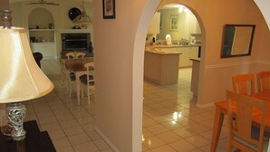 A spacious living room with a dining area, a kitchen, and an open-plan layout.