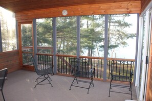Enjoy a serene view of the water and surrounding trees from this deck.