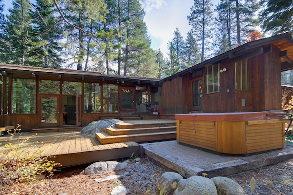View of 2 wings of the house, large two level deck, and 8 person hot tub