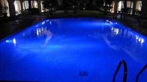 A swimming pool with a blue light. - Simply the Best at the Most Reasonable Price-Cayman Reef Resort #2 (George Town)