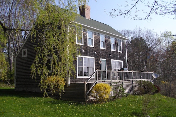 Front of the house with deck and gas grill