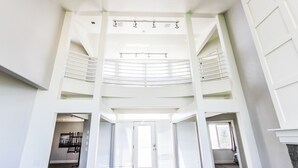A spacious, multi-level interior with a central staircase, large windows, and a modern design. - King Of The Mountain, Panoramic View, allows UP TO 40 Guests Completely Seclude (Laketown)