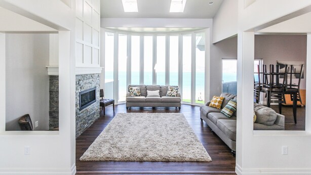 A spacious living room with a fireplace, a large window with a view, and a cozy seating area. - King Of The Mountain, Panoramic View, allows UP TO 40 Guests Completely Seclude (Laketown)
