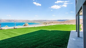 A view of a green lawn with a clear blue sky and distant mountains. - King Of The Mountain, Panoramic View, allows UP TO 40 Guests Completely Seclude (Laketown)