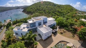 Una casa moderna amb panells solars, piscina i vistes al mar.