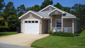 A single-story house with a garage, a front porch, and a number '203' on the door.