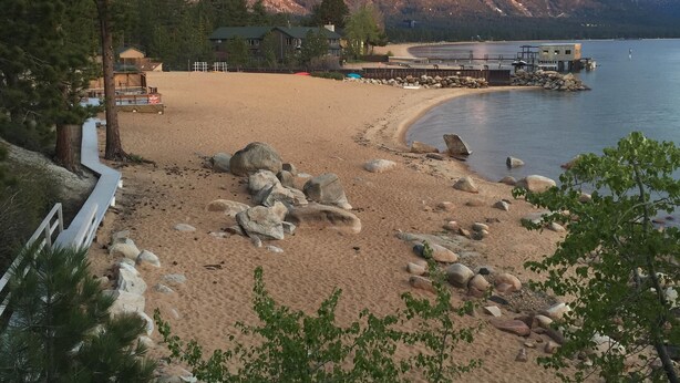 A beach with a wooden walkway, a dock, and a mountain in the background. - Private neighborhood beach, gated community. 3 miles from casinos -8ppl (Zephyr Cove)