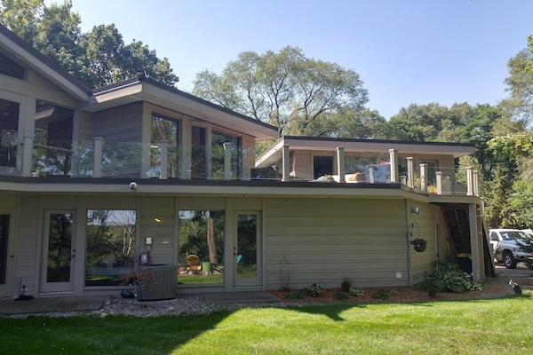 View of guest house on the right and attached to the main house via large deck.