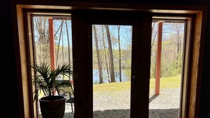 A window with a view of a forest and a gravel path. - Heron Landing:  Escape to Lake Mayo.
Private cove, where nature abounds! 



 (Roxboro)
