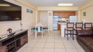 A compact living space with a dining area, a kitchen, and a seating area.