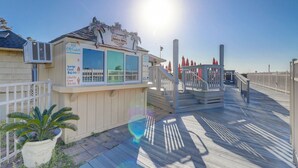 A beachside ice cream stand with a sign advertising large and waffle cones.