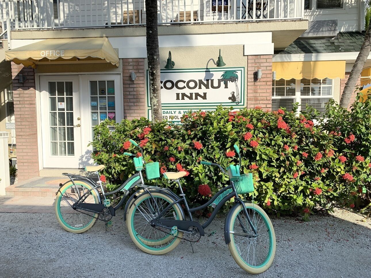 A building with a sign for 'Coconut Inn' and a bicycle parked in front.