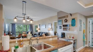 A kitchen with a wooden countertop, stainless steel sink, and a coffee station. - Red Rooster Retreat,Hot Tub+game area+firepit & LRG deck w/amazing Mountain View (Franklin)