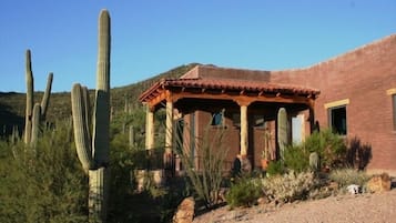 Experience the authentic charm of the Southwest in this traditional adobe-style building surrounded by desert landscapes and native vegetation.