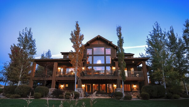 A large, two-story building with a prominent balcony and large windows. - Spring Shores Lodge - Luxury mountain estate on a private lake. With 3 en-suite king bedrooms 4 other bedrooms and 2 large bunkrooms, it sleeps up to 40 guests—perfect for family reunions, retreats, and group getaways in a secluded luxury setting. (Ashton)
