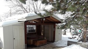 A small wooden structure with a porch, a door, and a window. - Luxury Townhouse at the Gateway to the Utah Canyons, Best Price On VRBO! (Cottonwood Heights)