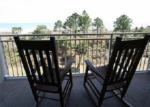 Enjoy the serene ocean views from this balcony with two comfortable chairs.