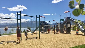 A playground with swings, slides, and climbing structures. - Lake Dillon Condominium with Beautiful Lake & Mountain Views. Sleeps 4. (Dillon)