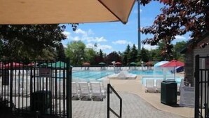 A swimming pool area with lounge chairs and umbrellas. - MASTHOPE-BIG BEAR-LACKAWAXEN-LUXURY 4 Bedroom-Game Room (Lackawaxen)