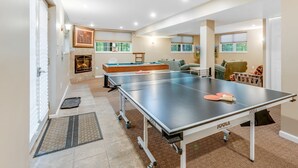 A spacious room with a ping pong table, a pool table, and a fireplace. - MASTHOPE-BIG BEAR-LACKAWAXEN-LUXURY 4 Bedroom-Game Room (Lackawaxen)