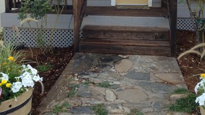 A house with a stone pathway leading to a wooden front door marked with the number 6020. - Foresthill Getaway is located in town and close to many wedding sites. (Foresthill)