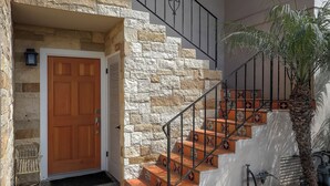 A stone staircase with a wooden door and metal railings. - Prime Montecito Beach Location (Montecito)