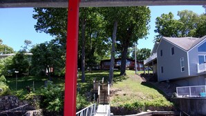 A wooden bridge over a river with a house on the right bank. - Lake front (Sunrise Beach)