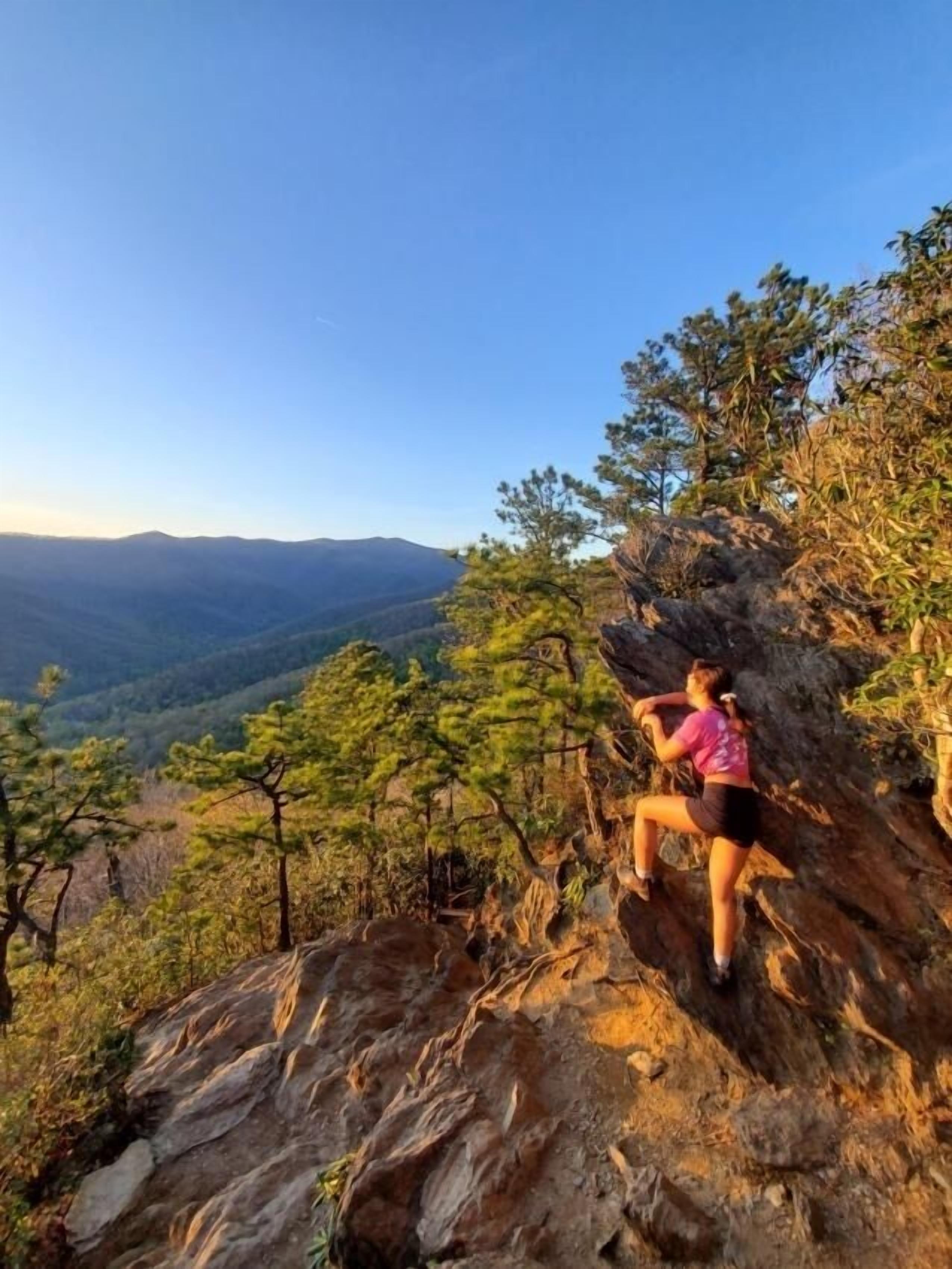 A person climbing a rocky mountain.