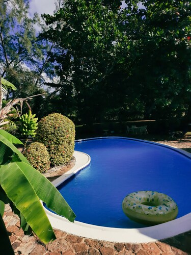 Beautiful garden villa. Family friendly. Just a short walk to a private beach. 