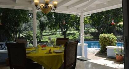 Beautiful garden villa. Family friendly. Just a short walk to a private beach.