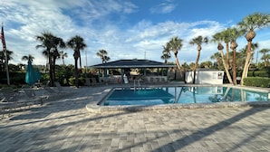 A swimming pool with lounge chairs and a covered pavilion. - Luxury condo steps away from Siesta Key public beach  (Siesta Key)