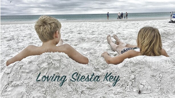Two people lying on a sandy beach with the ocean in the background. - Luxury condo steps away from Siesta Key public beach  (Siesta Key)