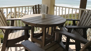 A wooden deck with a table and chairs, overlooking a beach with a view of the ocean. - Gulf-front,Pool,Balcony, VIEWS, 30A, Private Beach, Grill (Santa Rosa Beach)