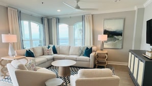 A modern living room with a sectional sofa, two armchairs, a coffee table, and a TV stand. - Gulf-front,Pool,Balcony, VIEWS, 30A, Private Beach, Grill (Santa Rosa Beach)