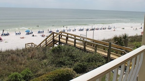 A beach with a wooden staircase leading down to the sand, a clear view of the ocean, and beach umbrellas and lounge chairs. - Gulf-front,Pool,Balcony, VIEWS, 30A, Private Beach, Grill (Santa Rosa Beach)