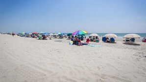A beach with rows of beach umbrellas and lounge chairs. - South Beach Resort-Beautiful Beach Resort for Family Fun!! (Myrtle Beach)