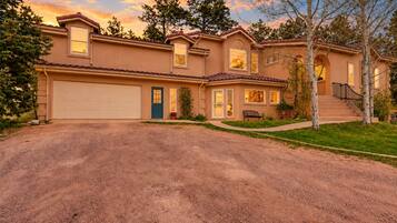 A two-story house with a garage, a front door, and a staircase leading to the second floor.