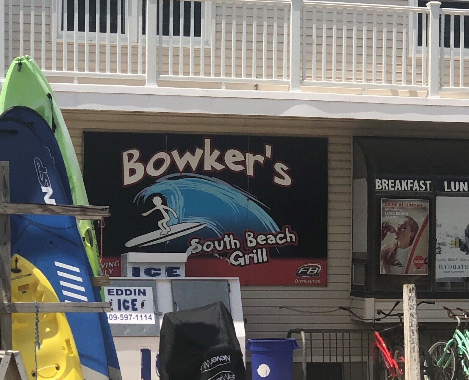 A storefront with a sign for Bowker's South Beach Grill.
