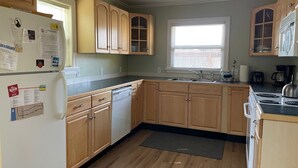 A kitchen with wooden cabinets, a dishwasher, a sink, and a stove. - Manzanita Beach Charmer! Dog Friendly Home with a Short Walk to Beach ~MCA#1012 (Manzanita)