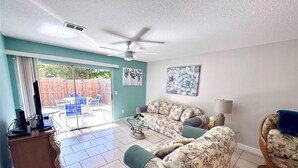 A living room with a sofa, a chair, a coffee table, and a television on a stand. - 5 minutes drive to nr Siesta Key  2BR/2BA condo Sienna Park. heated pool.. (Sarasota)