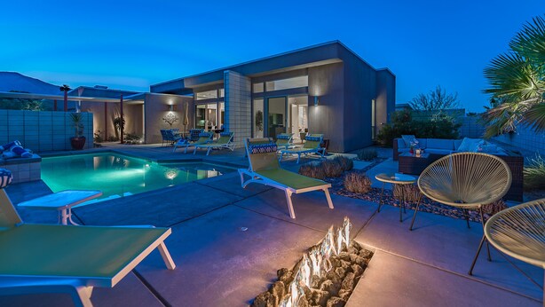 A modern house with a swimming pool, lounge chairs, and a fire pit. - PS Paradise: Contemporary Modern Home; Large with Modern Comforts (Palm Springs)