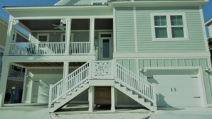 A two-story house with a balcony, a front porch, and a garage. - Book now for 2026 (Orange Beach)
