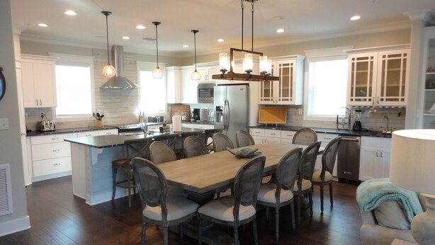 A spacious kitchen with a central island, modern appliances, and pendant lighting. - Book now for 2026 (Orange Beach)