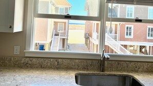 A kitchen with a large window, a sink, and a ceiling fan. - Beach Block Rental - Ocean/Beach Out Your Back Door. Great Location At Beach!!! (Point Pleasant Beach)