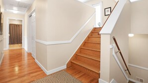 A staircase with wooden steps and white handrails, leading to an upper floor. - Beach Block Rental - Ocean/Beach Out Your Back Door. Great Location At Beach!!! (Point Pleasant Beach)