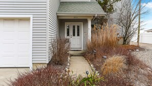 A two-story house with a front door, garage, and a small front yard with plants and a pathway. - Beach Block Rental - Ocean/Beach Out Your Back Door. Great Location At Beach!!! (Point Pleasant Beach)